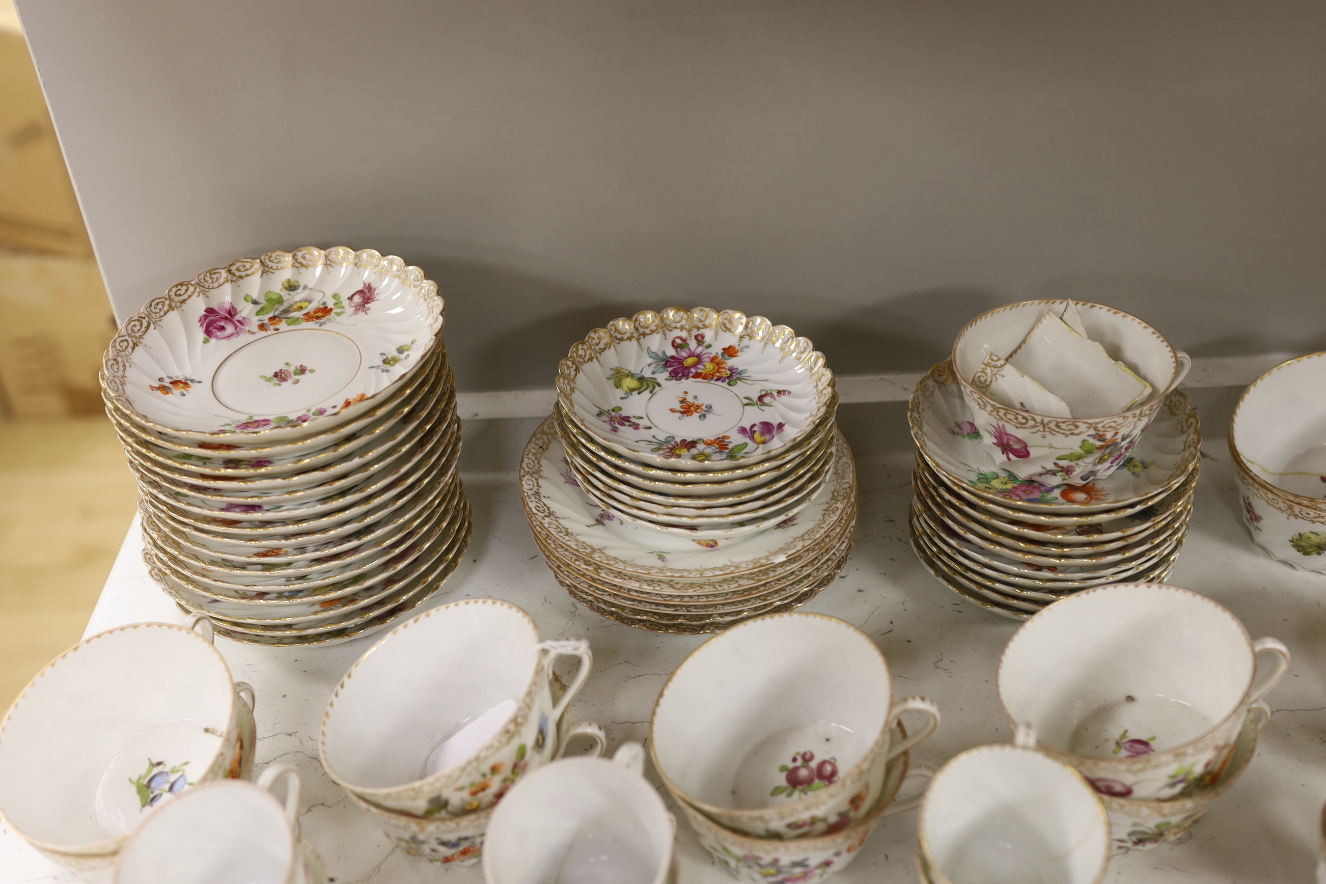 A quantity of Dresden flower painted tea wares